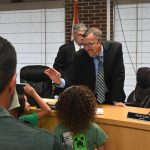 R.J. Santore high-fiving his daughter after his swearing-in last Thursday. (© FlaglerLive)