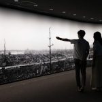 Visitors to the Hiroshima Peace Memorial Museum in Hiroshima view a large-scale panoramic photograph of the destruction following the 1945 bombing. (Carl Court/Getty Images)