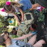 Volunteers of all ages plant around the coquina base for Garfield the Turtle, located at the entrance of the Palm Coast Historical Society in Holland Park. (Palm Coast)