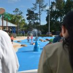 Milissa Holland, right, with County Commissioner Dave Sullivan, at her last public event as mayor, at Palm Coast's newly opened splash pad in mid-May. (© FlaglerLive)