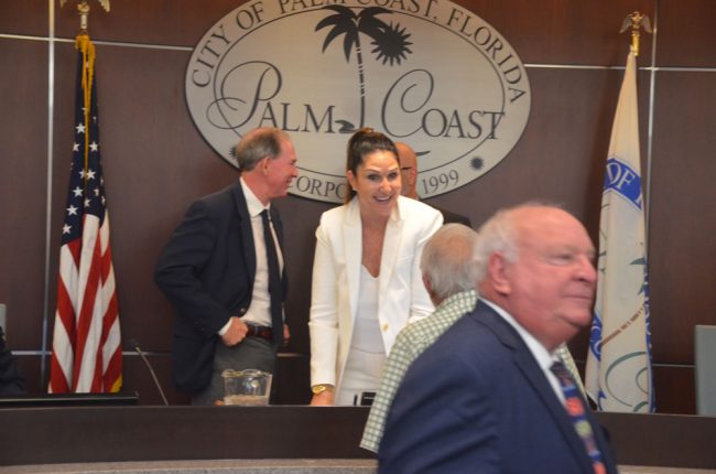 Milissa Holland after her swearing-in as mayor in 2016, speaking to Jack Carrell as former Mayor Jon Netts was passing. (© FlaglerLive)