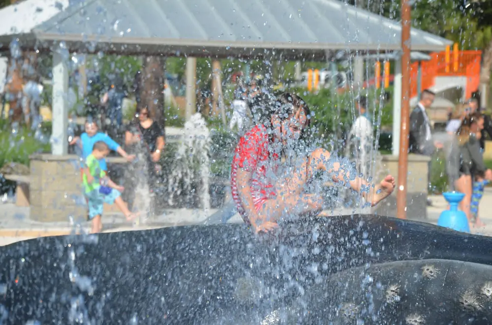 Children (and politicians) kicked off the splash pad at Holland Park this morning. (© FlaglerLive)