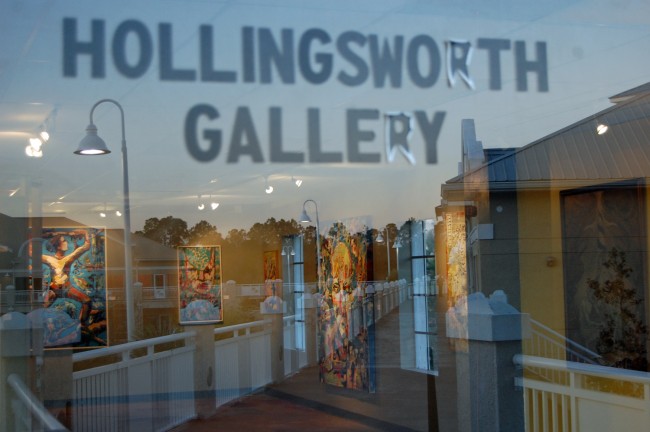 JJ Graham's Hollingsworth Gallery, seen here filled with his own paintings, has anchored the arts community in Palm Coast at City Marketplace for the past six years. That era is drawing to a close, as Hollingsworth will move a few miles south, to Nature Scapes, in Bunnell. Click on the image for larger view. (© FlaglerLive)