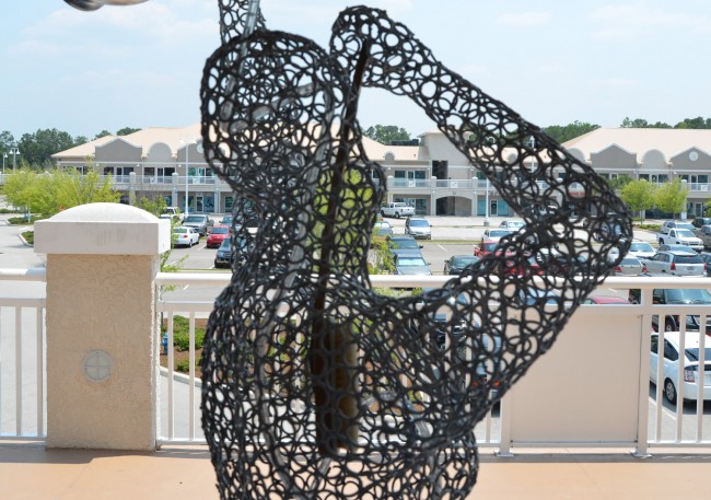 Palm Coast's and Flagler's potential as an arts engine is getting a good scrubbing: a detail from a sculpture that used to look out from Holliongsworth Gallery onto City Marketplace, which has been somewhat of a hub of Palm Coast arts. (© FlaglerLive)