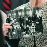 Irene Fogel Weiss holds a photograph of her mother and brothers, who were killed during the Holocaust, during a ceremony at the U.S. Capitol on April 14, 2026, in Washington.