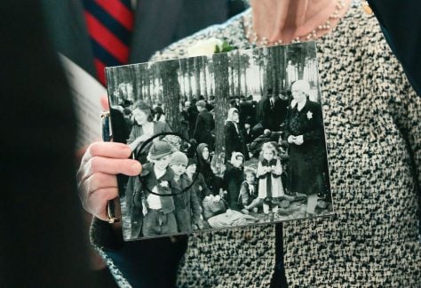Irene Fogel Weiss holds a photograph of her mother and brothers, who were killed during the Holocaust, during a ceremony at the U.S. Capitol on April 14, 2026, in Washington.