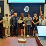 Kadance Nickmeyer, center, with her mother, the Bunnell City Commission, the Bunnell City Manager and the police chief last week. (Bunnell)