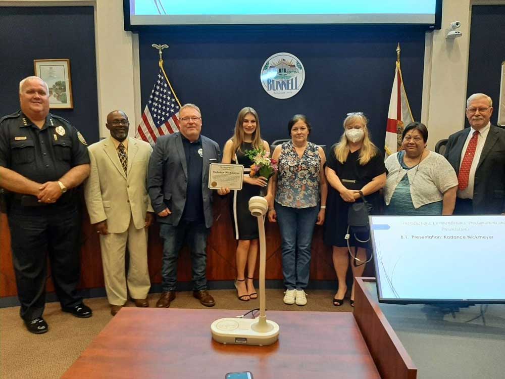 Kadance Nickmeyer, center, with her mother, the Bunnell City Commission, the Bunnell City Manager and the police chief last week. (Bunnell)