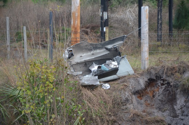 The semi traveled across the pond (more than 30 feet across) before crashing down, leaving parts of its hood on the other side of the embankment. Click on the image for larger view. (© FlaglerLive)