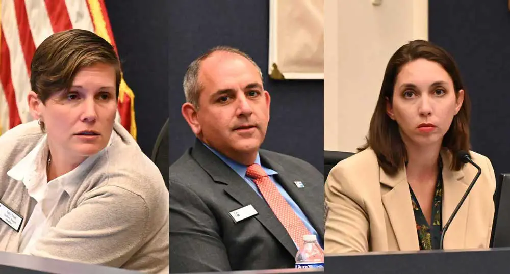 Flagler County School Board member Sally Hunt, left, joined hands with Will Furry and Christy Chong to fire Superintendent Cathy Mittelstadt. (© FlaglerLive)