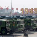 Military vehicles carry an earlier version of China’s hypersonic missile during a 2019 parade.