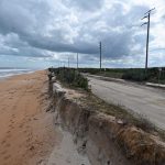 Hurricanes Ian and Nicole left only a sliver of sand between the high-tide waterline and State Road A1A at the south end of Flagler County. many other parts of A1A suffered the same fate. The state Department of Transportation has been rebuilding protections with rock revetments and sand. (© FlaglerLive)