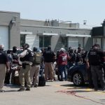 Federal immigration agents converge on Glenn Valley Foods in Omaha, Neb., on June 10 for an immigration raid. A new analysis released Thursday estimates mass deportations could cost more than 6 million jobs, a figure that includes both immigrants and U.S.-born workers. (Photo courtesy of U.S. Immigration and Customs Enforcement via Nebraska Examiner)