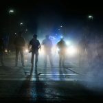 Federal immigration officers are seen outside the Bishop Whipple Federal Building in Minneapolis on Jan. 12, 2026.