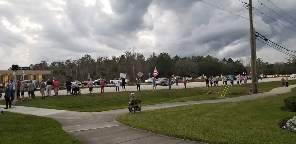 Indivisible Flagler's demonstration in Palm Coast in support of the impeachment of President Trump, echeduled in the House of Representatives on Wednesday afternoon. The demonstration took place along State Road 100, near Panera Bread, one of 600 such demonstrations across the country. (© FlaglerLive)
