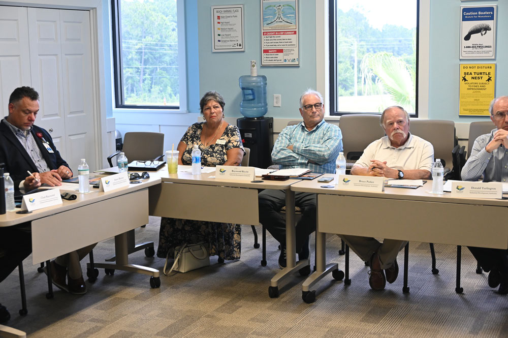 Some of the members of the Industrial Authority Board at a previous meeting. From left, Shawn Rhoto, County Commissioner Pam Richardson, the commission's liaison on the board, Chair Ray Ricchi, Bruce Parker and Don Turlington. (© FlaglerLive)
