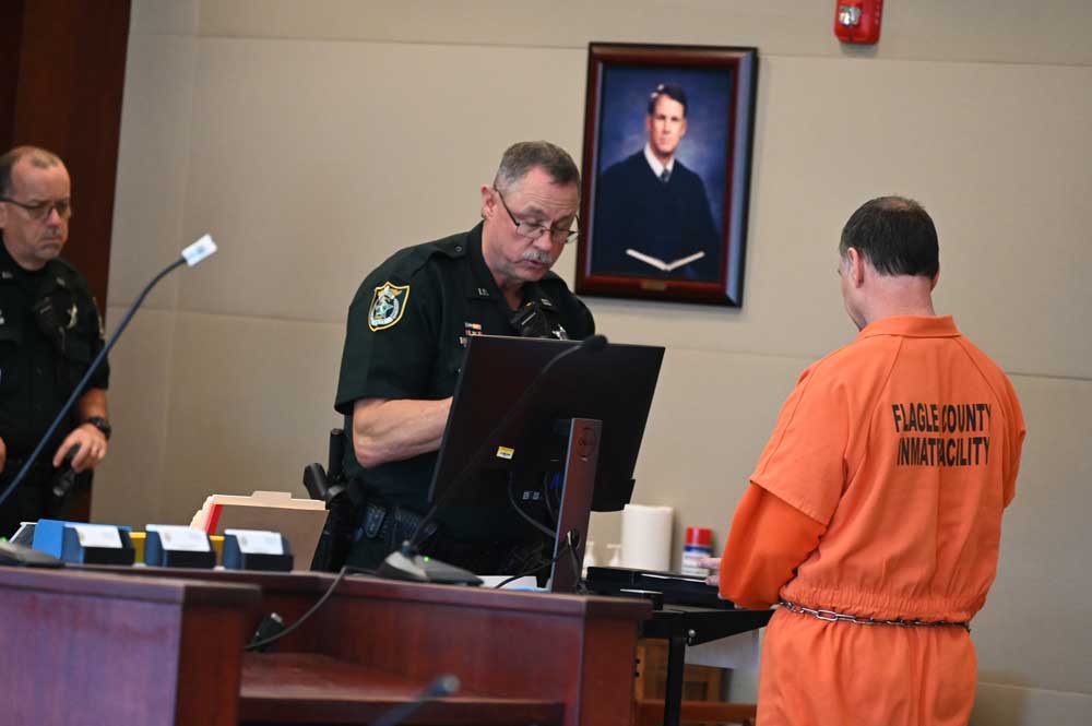 A Flagler County inmate getting processed, after his sentencing, for entry into the Department of Corrections system last May. (© FlaglerLive)