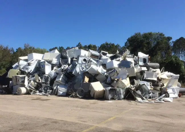 At Flagler Beach's sanitation facility, a mound about 10 to 12 feet high has risen, a mass of residents' appliances ruined by Hurricane Irma flooding. Click on the image for larger view. (© FlaglerLive)