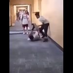 A capture from a brief video of a fight at Indian Trails Middle School, posted by the father of the boy being assailed in the video. The mother of the child faces a felony charge for her role in an alleged retaliation to the beating in the hallway.
