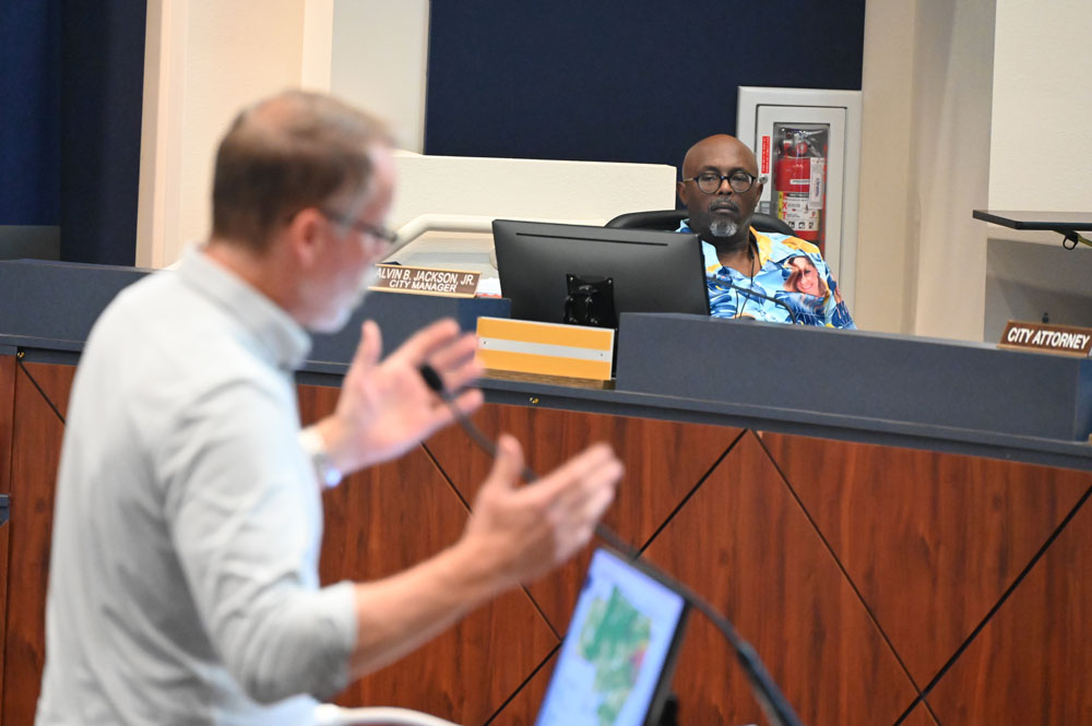 Bunnell City Manager Alvin Jackson at a City Commission meeting as Chad Grimm, developer of the 6,100-home Reserve at Haw Creek the commission approved, spoke. (© FlaglerLive)