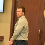 Jayden Jackson today during his sentencing hearing. The two Florida Highway Patrol troopers in the foreground are the traffic homicide investigators who investigated Jackson's hit-and-run crash that took the life of Shaunta Cain. 54, on U.S. 1 in 2022. (© FlaglerLive)