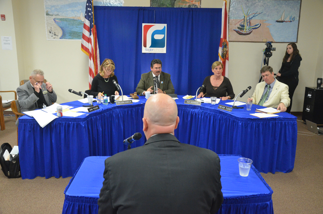 Jacob Oliva is usually seated alongside Flagler County School Board members, as their acting superintendent. Thursday morning, he was acing them for two hours in a broad-ranging job interview. (© FlaglerLive)