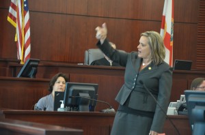 Assistant State Attorney Jacquelyn Roys recreating the shooting, as she did several times during closing arguments Friday morning. click on the image for larger view. (c FlaglerLive)