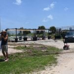 James Powell Sr., left, working at midday today on the future grounds of Ragga Surf Cafe on the Dolphin Adventure's property. (© FlaglerLive)