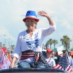Jane Gentile-Youd in the 2018 July 4 parade in Flagler Beach, campaigning for the County Commission. (© FlaglerLive)