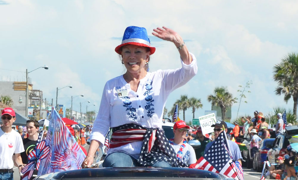 Jane Gentile-Youd in the 2018 July 4 parade in Flagler Beach, campaigning for the County Commission. (© FlaglerLive)