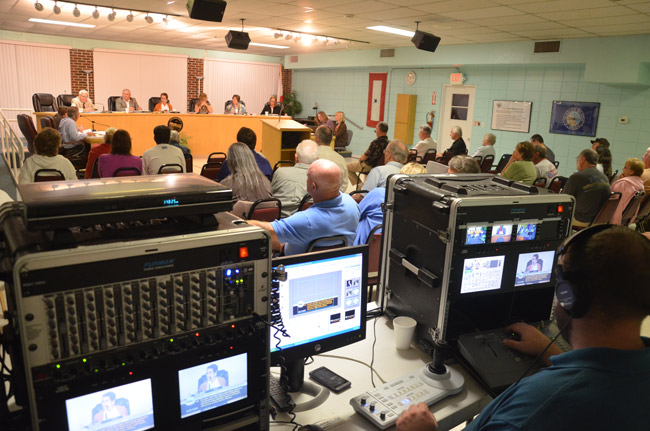 Palm Coast TV's Jason Giraulo at the controls during a Flagler Beach City Commission meeting. The production set-up will be history beginning in October, when Flagler Beach replaces the system with live, web-streaming of meetings through a single camera in back of the meeting room. (© FlaglerLive)