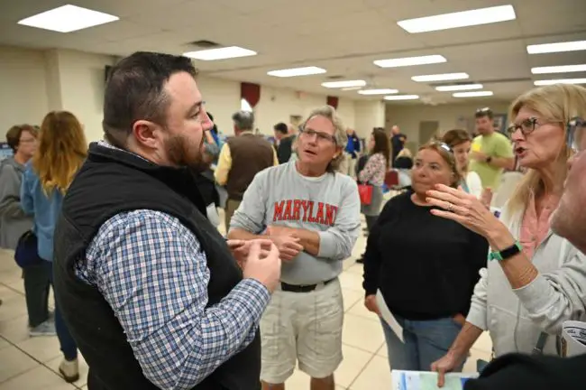 The U.S. Army Corps of Engineers' Jason Harrah, left, speaking with residents Tuesday. (© FlaglerLive)