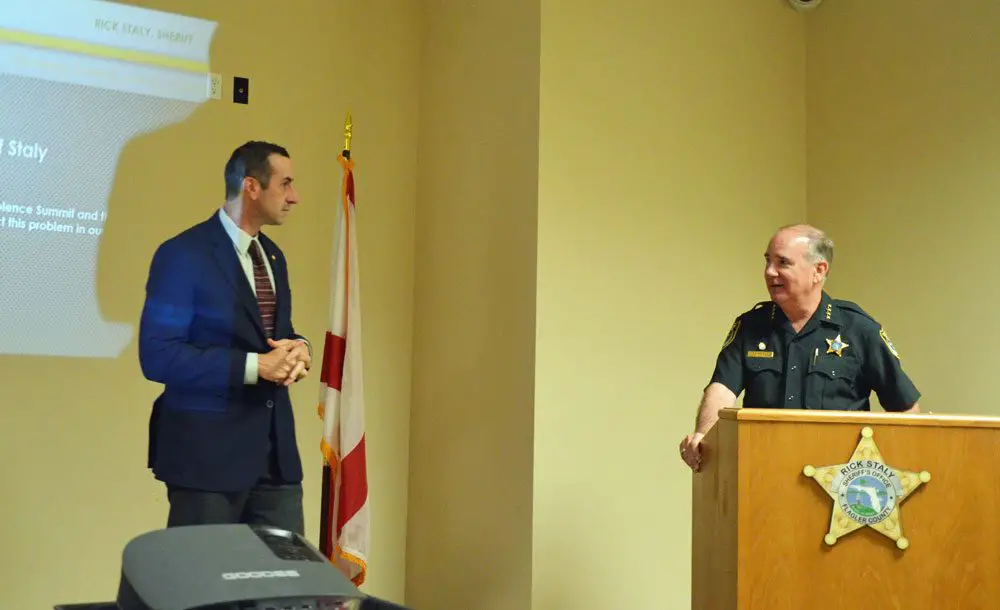 Assistant State Attorney Jason Lewis, left, with Sheriff Rick Staly at today's update on the sheriff's domestic violence initiative, the sixth since the initiative launched in 2017. (© FlaglerLive)