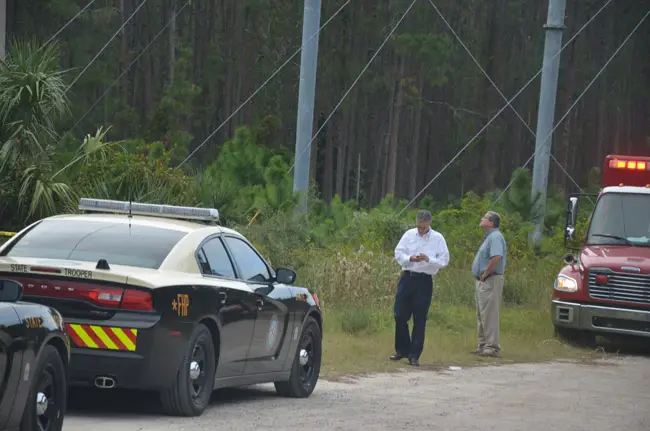 Jay Gardner, Flagler County's property appraiser and a long-time co-owner of the plane that crashed, near the scene of the crash, which was deep in the woods and not accessible except to emergency personnel. (© FlaglerLive)