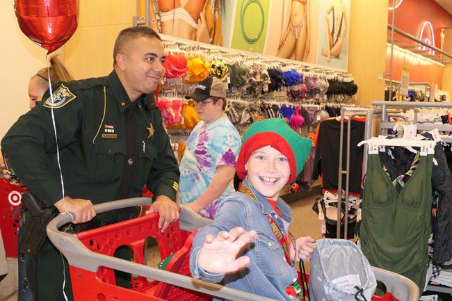 Jeffrey Foust, 11, with Flagler County Sheriff's Cmdr. Phil Reynolds at the Christmas with a Deputy event on Friday evening. (FCSO)