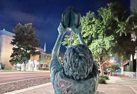 Jeff Whipple's "The Reader" (concrete and paint), at 123 South Adams Street in Tallahassee. (© FlaglerLive)
