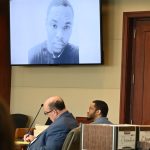 A portrait of murder victim Deon Jenkins shown the jury during the prosecution's opening arguments, as Marcus Chamblin, the defendant (right), watched, with his attorney, Terence Lenamon. (© FlaglerLive)