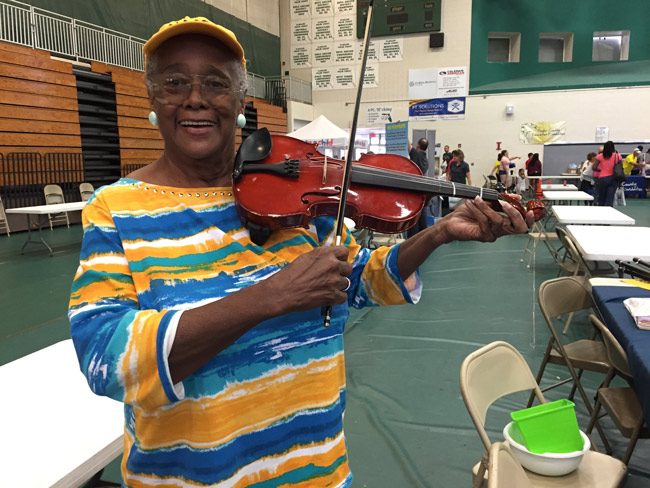 NAACP education advocate Jerusha Logan showed a few skills at Saturday's Back To School Jam at Flagler Palm Coast High School. The Jam drew an estimated 900 families, according to a school board member.  (© FlaglerLive)