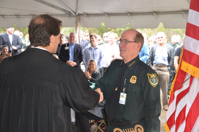 Flagler County Circuit Judge Dennis Craig administered the oath of office to Jim Manfre for his second go-around. (© FlaglerLive)