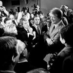 President Jimmy Carter, right, surrounded by journalists after announcing he was lifting the travel ban on Cuba, Vietnam, North Korea and Cambodia, March 9, 1977.