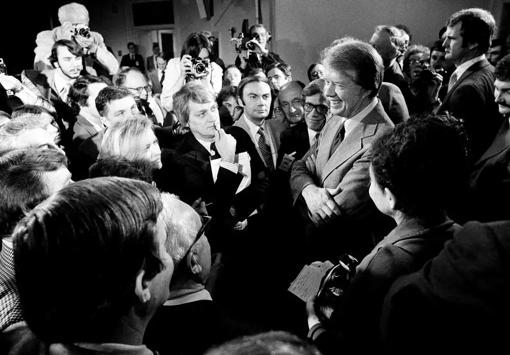 President Jimmy Carter, right, surrounded by journalists after announcing he was lifting the travel ban on Cuba, Vietnam, North Korea and Cambodia, March 9, 1977. 