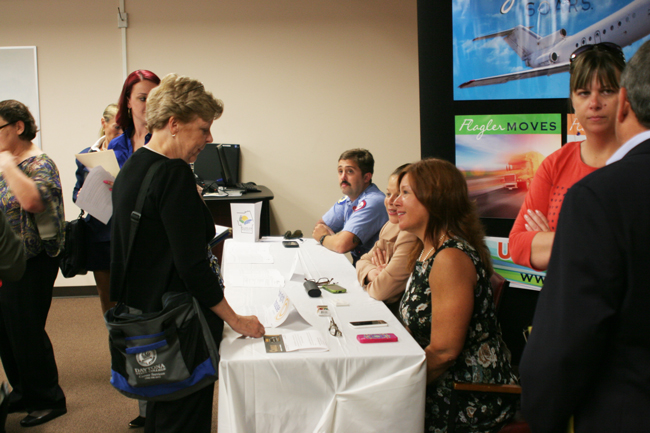 Employers and applicants filled a chamber at the county's Emergency Operations Center Thursday for a job fair. In red, to the right, is Rebecca DeLorenzo, president of the Flagler County Chamber of Commerce. (Flagler County)