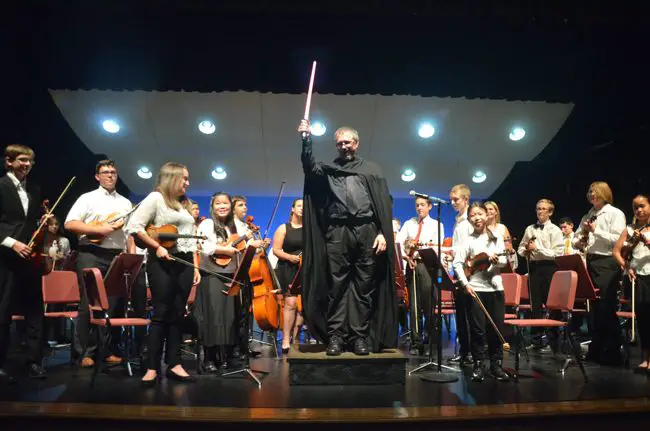 Conductor Joe Corporon at the end of a performance of the Star Wars theme at last May's concert. The Force, and the entire Flagler Youth Orchestra, are back Wednesday for their first full-scale performance of the year at the Flagler Auditorium. (c FlaglerLive)