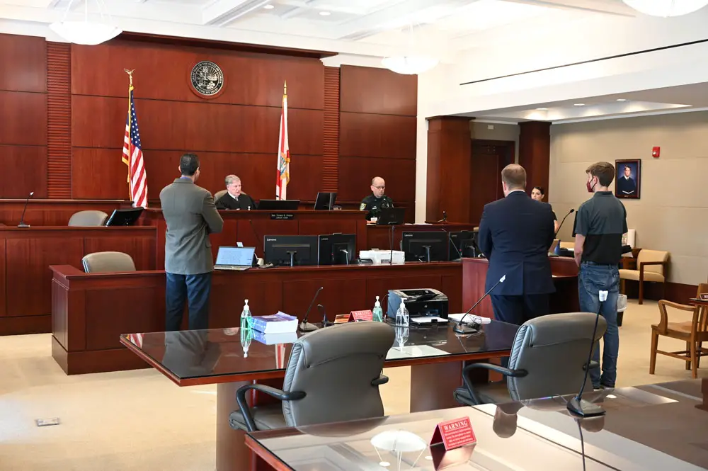 Circuit Judge Terence Perkins explaining the terms of sentence to Joey Renn Jr., 22, right, who stood with his lawyer, Jefferey Higgins. Assistant State Attorney Jason Lewis is to the left. (© FlaglerLive)