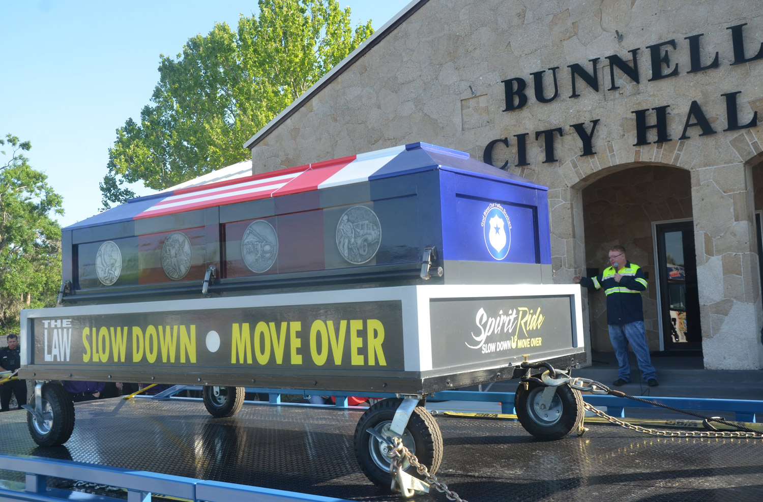 John Rogers, Bunnell's vice mayor and long-time owner of John's Towing, this morning emceed the Spirit Ride ceremony's stop in the city before towing the ceremonial casket to its next stops in Deltona and Heathrow. (© FlaglerLive)