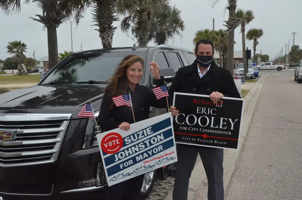 Suzie Johnston and Eric Cooley late this afternoon, a distance from the polling station at City Hall in Flagler Beach. (© FlaglerLive)