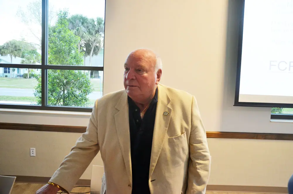 The late Jon Netts, who had been Palm Coast's mayor and a member of the council, in a speaking appearance at the Palm Coast Community Center in April 2018. His family would like the center named after him. David Alfin, the current mayor, is cool to the idea. (© FlaglerLive)