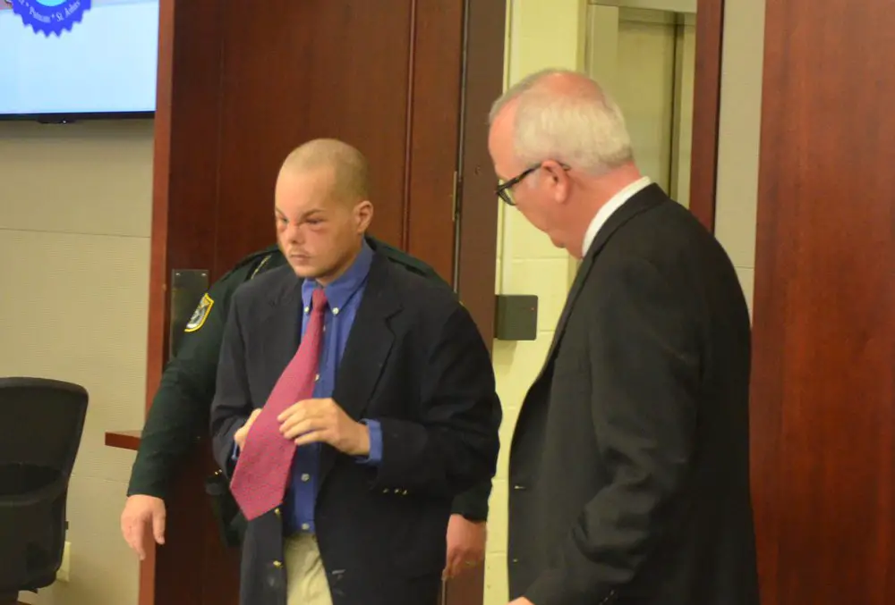 JOseph Bova arriving for the second afternoon session in his trial on a first-degree murder charge this afternoon in circuit court in Bunnell. One of his attorneys, Assistant Public Defender Matt Phillips, is to the right. (© FlaglerLive)