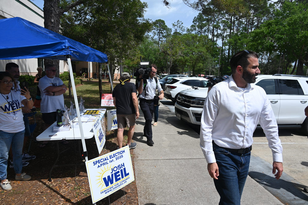 Josh Weil campaigning in Palm Coast on the last day of the special election for a congressional seat last April 1, which he lost to Randy Fine. (© FlaglerLive)