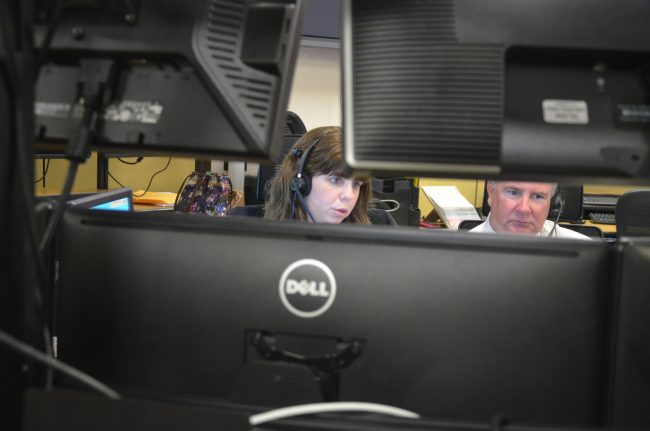 Veteran 911 dispatcher Josie Gannon trained Sheriff Rick Staly for four hours at Flagler County's 911 center Wednesday. It was not a quiet shift. Click on the image for larger view. (© FlaglerLive)